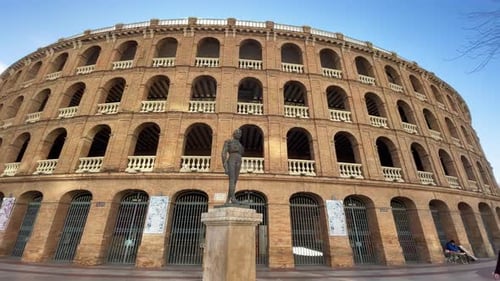 Statue of Toreador Manolo Montoliu against Plaza de Toros de Valencia