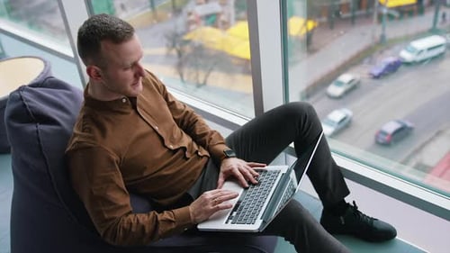 Handsome businessman in office by the window.