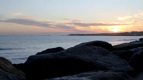 Defocused sunset over the sea, orange sky in the background.