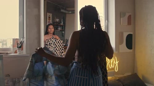 Stylish Young Adults Trying on Clothes Indoors