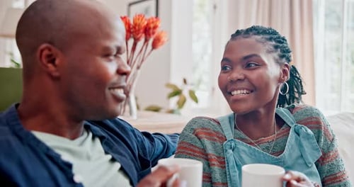 Happy Couple Conversing on Couch at Home