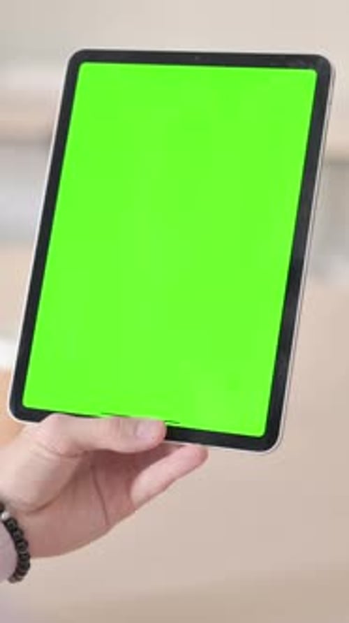 Rear View of Man Using Tablet with Green Chroma Screen, Vertical Video