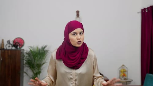Woman Gesturing Angrily While Talking Indoors