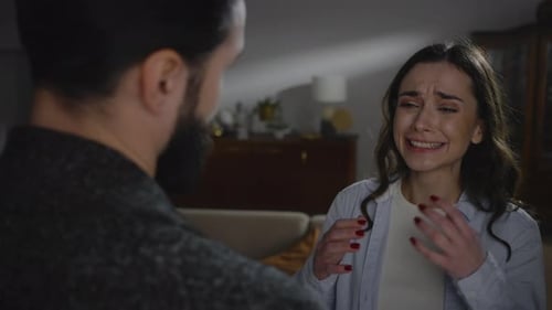 View From the Back to a Handsome Bearded Man Hugging and Consoling a Crying Offended Woman