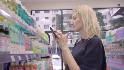 Purchase in cosmetics store Scanning QR code from bottle on smartphone,