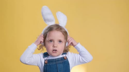 Happy Child Wearing Bunny Ears and Overalls