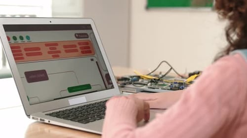 Back view of smart american girl coding engineering prompt at class. Pedagogy.