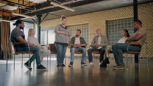 Adults Sit in Circle For a Support Group