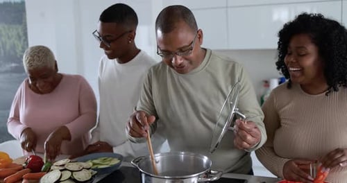 Happy Latin Family Having Fun Cooking Together Inside Kitchen at Home Africa