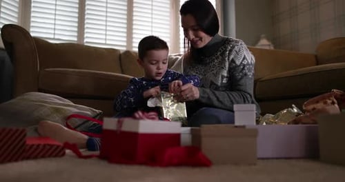 Mother and Son Opening Gifts Together Indoors
