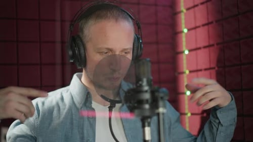 Man Expressing Focus While Recording in a Soundproof Studio Room