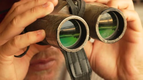 Close Up Of A Man Using Binoculars