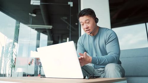 Asian male freelancer talking to colleagues in meeting room at modern office coworking. Business man