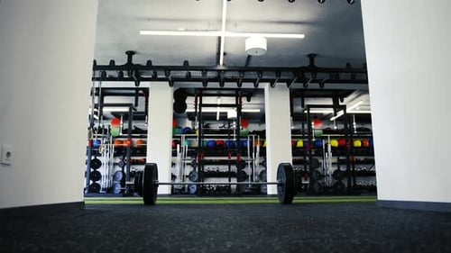 Metal Heavy Barbell Laid on the Floor in Modern Gym