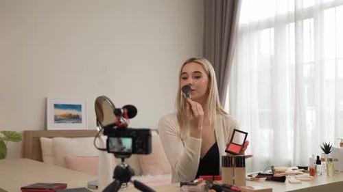 Attractive Woman Vlogging about Makeup in Bedroom