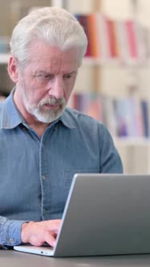 Focused Man Working on Laptop Indoors