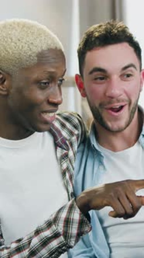 Affectionate Men Laughing Indoors Together