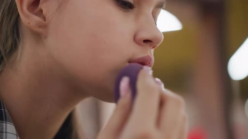 Partial View of Lady Perfecting Makeup Around Mouth with Sponge