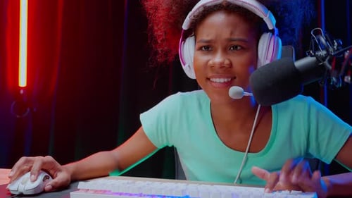 Focused Young Adult Gamer Smiling and Streaming