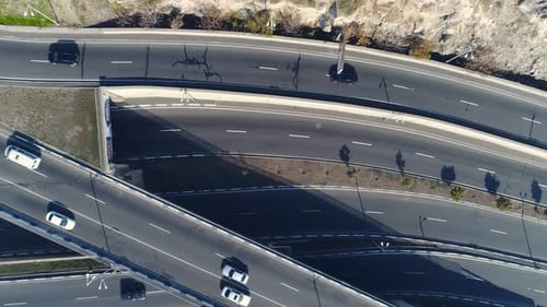 Drone view of interstate freeway with curvy autobahn and heavy traffic on summer day