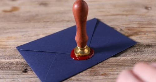 Sealing an Envelope with Red Wax and Stamp
