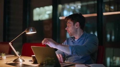 Late Worker Closing Laptop Tired of Overtime Work in Night Office Closeup