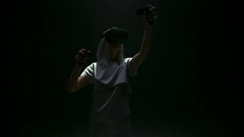 Woman wearing VR headset and holding controllers
