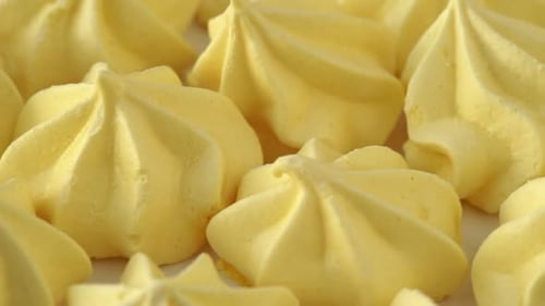 Yellow Meringue Rotates on Tray Food Dessert Background Bakery and Pastry Shop Concept