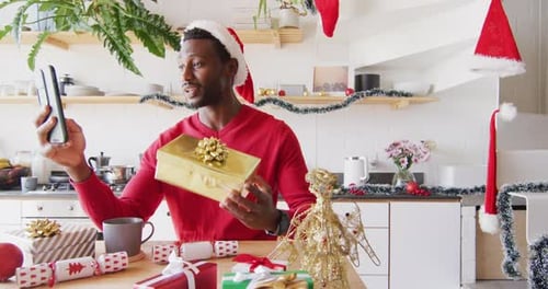 Man Video Calling Holding Gift at Christmas