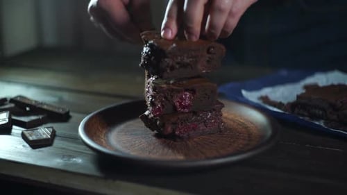 Stacking Delicious Brownie on Plate in Kitchen