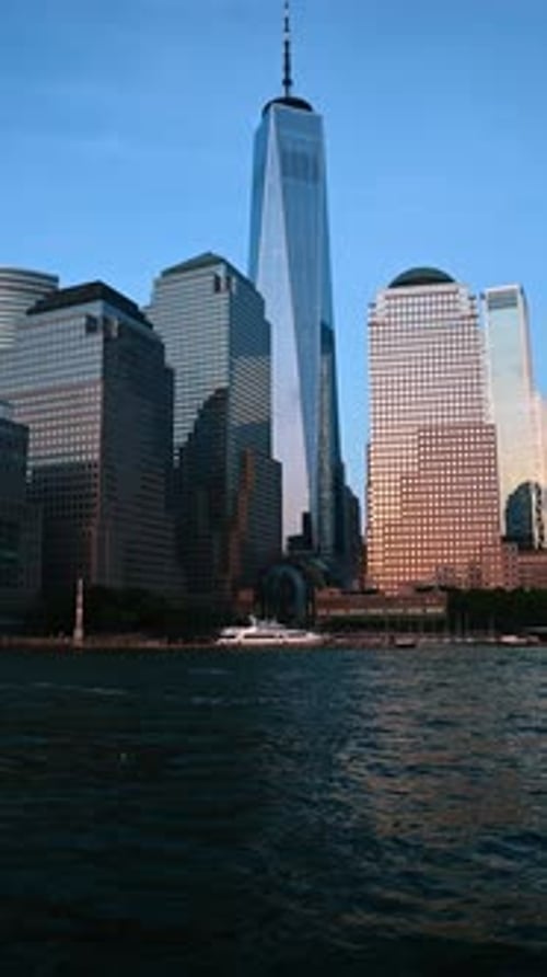 Yacht stands at the waterfront of New York, USA. Low angle view at the glass skyscrapers