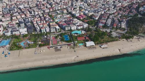 Aerial Video of a Coastal Paradise With White Sand Gentle Ocean Waves and a Modern City in the