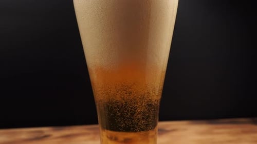 Beer Pouring Into Glass With Bubbles and Foam