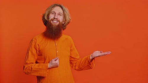 Young Man Showing Thumbs Up and Pointing at Right on Blank Space Place for your Advertisement Logo