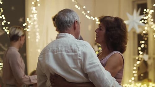 Family Celebrates Together With Dancing and Fairy Lights