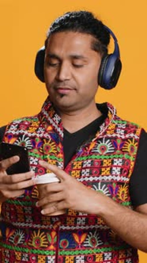 Vertical Video Man Listening Music Having Fun Dancing Drinking Coffee Studio Background