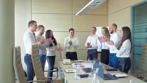 Business Team Applauding in Meeting
