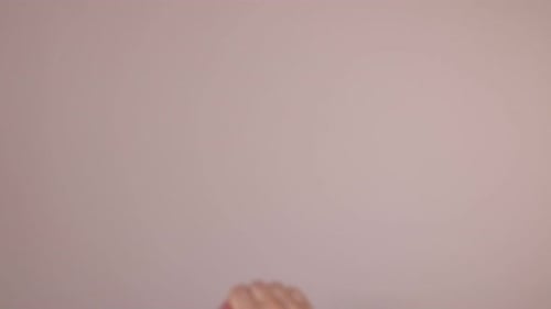 Man showing his palm on beige background, closeup