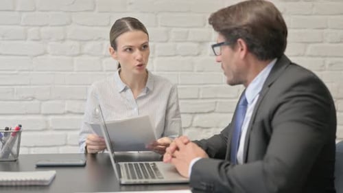 Colleagues Discussing Documents in the Office