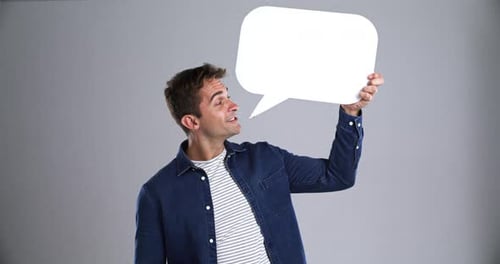 Excited Young Adult Holds Blank Speech Bubble