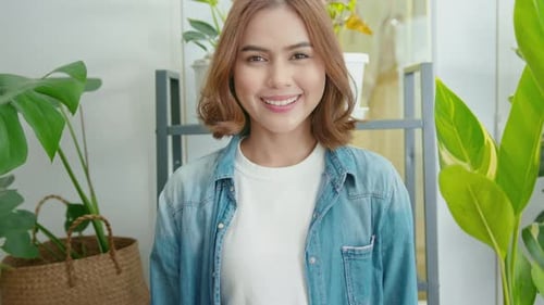 Close up young woman gardener is smiling