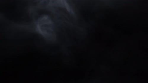 Billowing smoke or fog on a black background