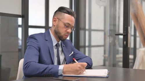 Hispanic Businessman Writing a Business Letter