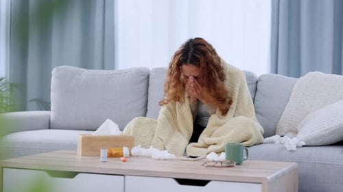 Sick woman suffering from covid, a flu virus or a cold infection during quarantine