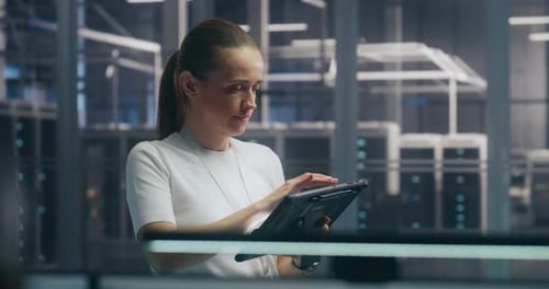 Woman Using Tablet Device in Data Center