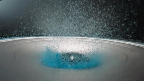 Bright Blue Powder Flies Up Near Dust Cap of Modern Dynamic