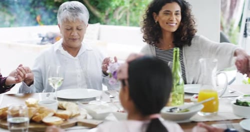 Family Gathering Together for Meal Praying