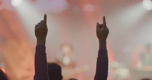Audience hands in the air at a concert
