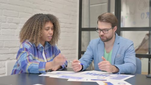 Young Teammates Working on Documents in Office