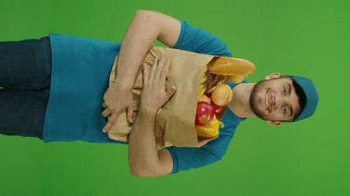 VERTICAL VIDEO Green Screen Delivery Man Brings Paper Bag with Food